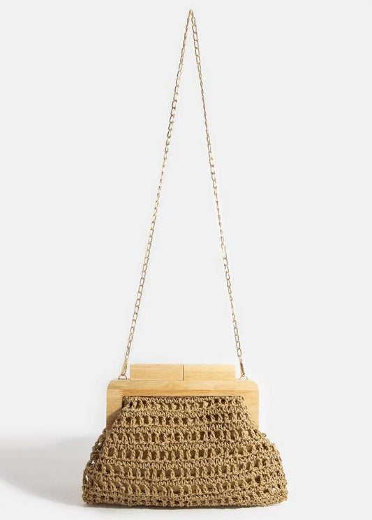 Woven handbag with wooden frame and chain strap on a white background