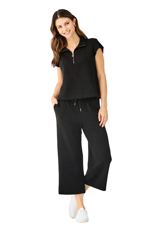 Woman wearing a black outfit with a white background