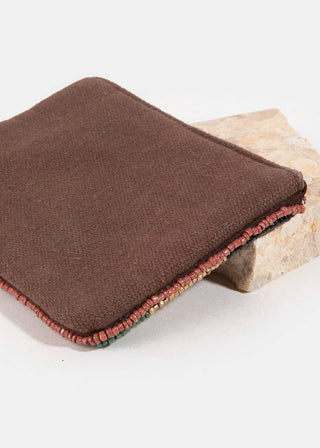 Brown folded fabric on a stone surface with a white background