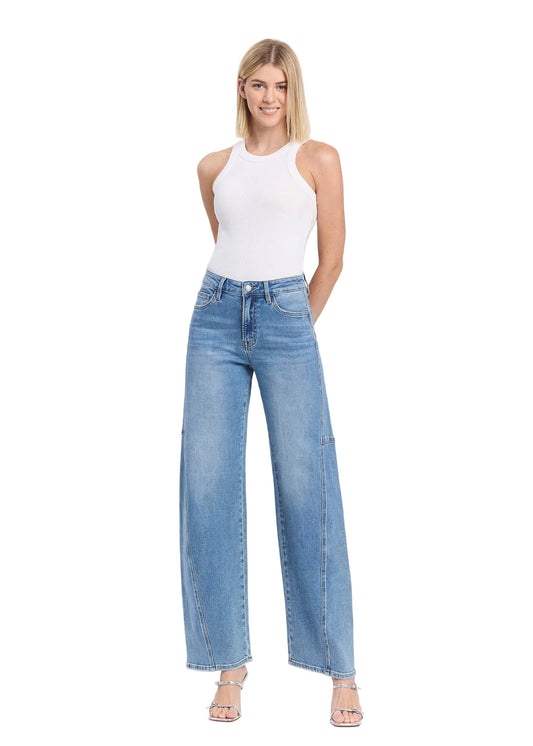 Woman wearing light blue jeans and a white top on a white background