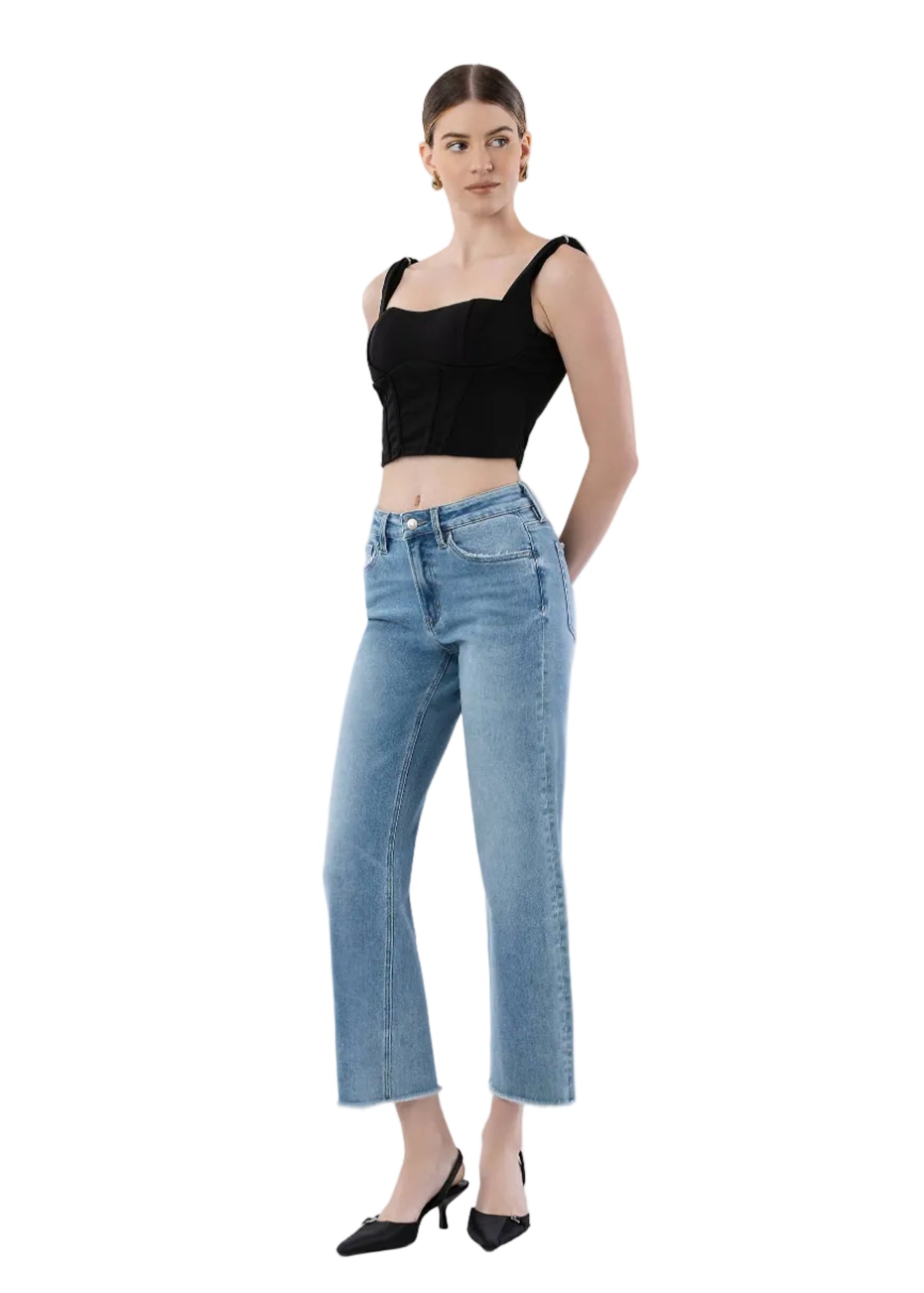 Woman wearing a black top and light blue jeans on a white background