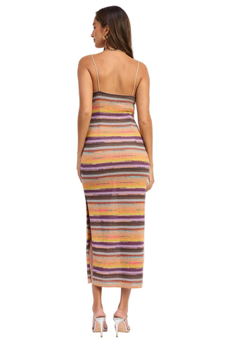 Woman wearing a multicolored striped dress on a white background