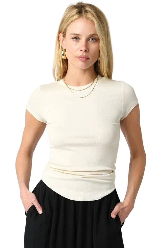 Woman wearing a white short-sleeve top and black pants on a white background