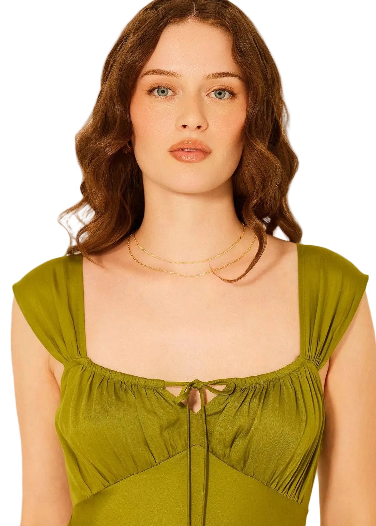 Woman wearing a green dress with a plain background