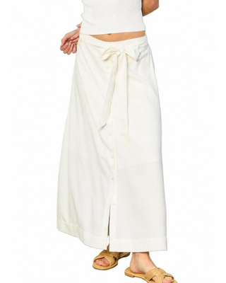 White wrap skirt worn by a person on a white background