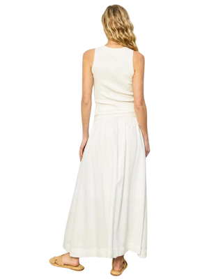 Woman wearing a white sleeveless dress on a white background