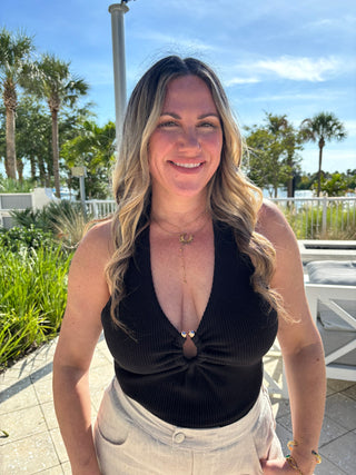 women in halter top with tropical background