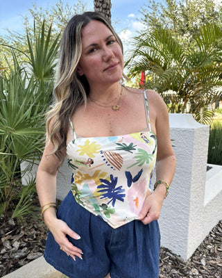 women in tropical print top with tropical background