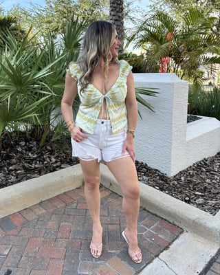 women in chevron top with tropical background
