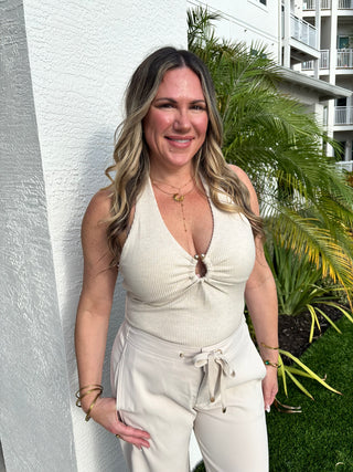 women in halter top with tropical background