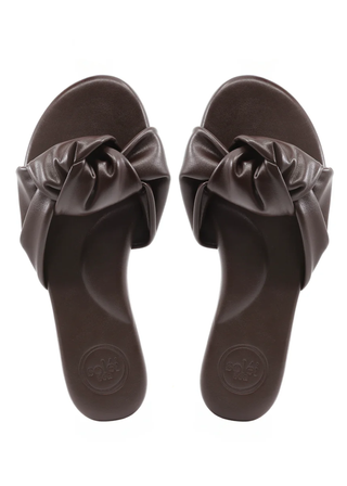 Pair of brown sandals with bow details on a white background