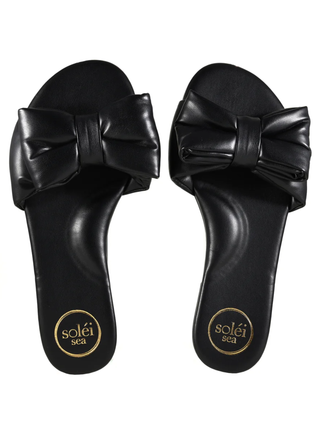 Black sandals with large bows on a white background
