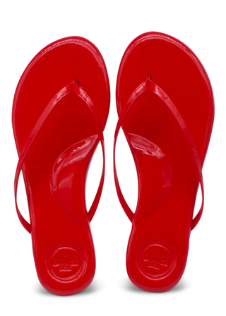 Pair of red flip-flops on a white background