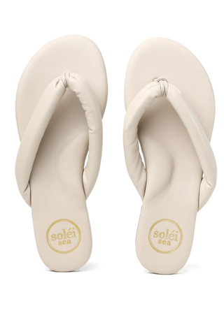 Pair of beige flip-flops with 'solei' branding on a white background