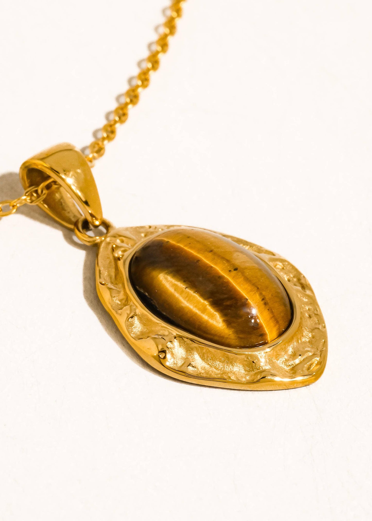 Gold pendant necklace on a white background