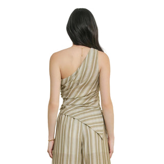 Woman wearing a one-shoulder striped dress against a plain background