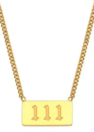 A gold-colored necklace with a rectangular flat oversized pendant engraved with the numbers 111.