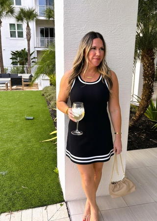 woman in black active dress with tropical background