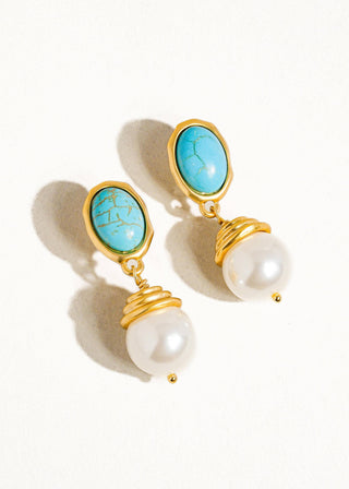 A pair of gold-plated earrings featuring faux pearl drops and turquoise-colored stones set in gold-toned metal.