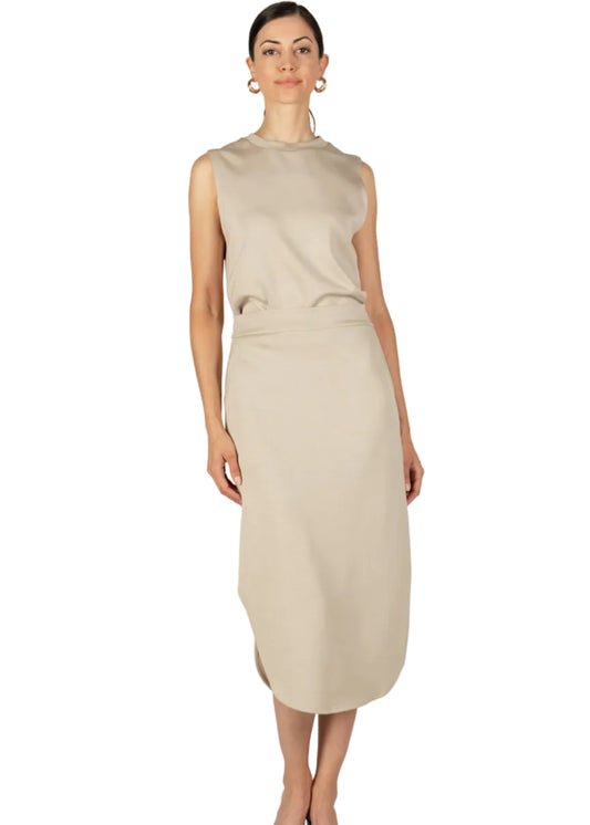 Woman wearing a beige midi skirt on a white background