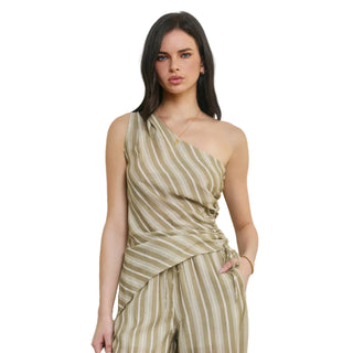Woman wearing a one-shoulder striped dress against a plain background