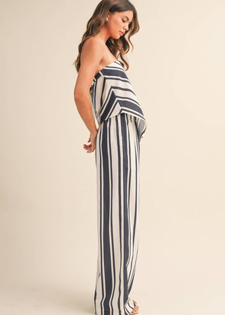 Woman wearing a striped dress against a plain background