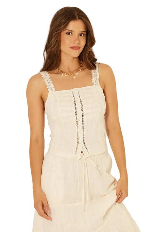 Woman wearing a white tank with lace straps on a white background