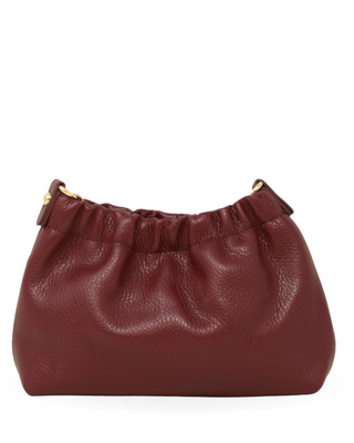 Brown leather handbag with gold zipper on a white background