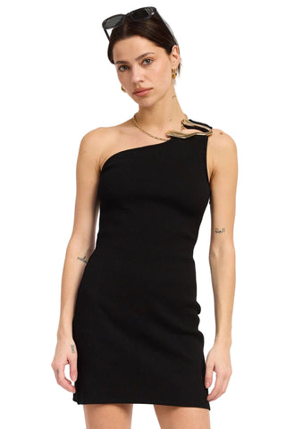 Woman wearing a black one-shoulder dress against a white background