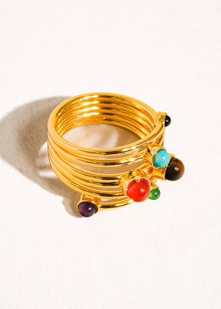 Gold bracelet with colorful beads on a white background