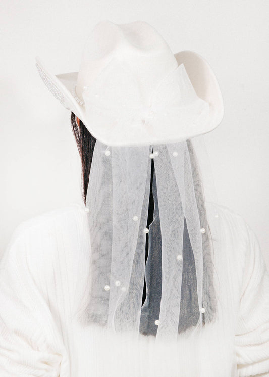White hat with tassels on a white background