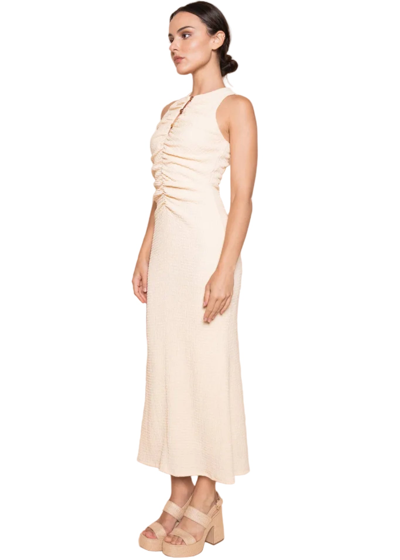 Woman wearing a white dress against a beige background