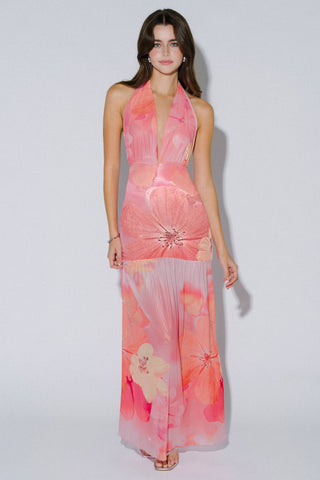 Woman wearing a pink floral dress on a white background