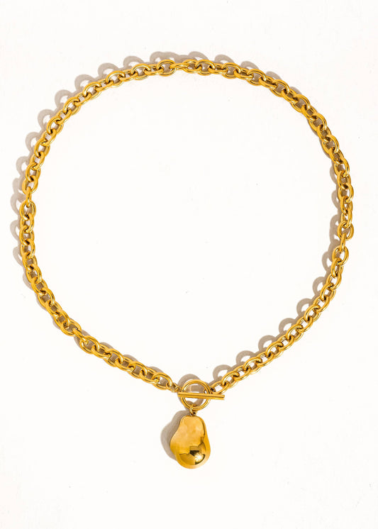 Gold chain necklace with a gold shell charm on a white background