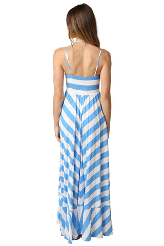 Woman wearing a blue and white striped dress on a beige background