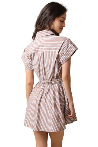 A woman wearing a short-sleeve collared dress with vertical brown and white stripes, shown from the back against a plain beige background.