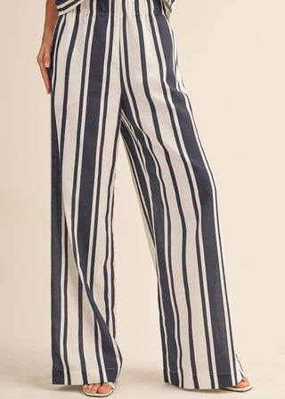 Navy and white striped pants on a beige background