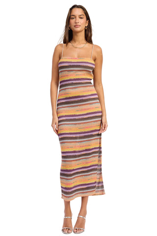 Woman wearing a multicolored striped dress on a white background