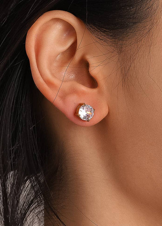 Close-up of an ear wearing a sparkling stud earring with dark hair.